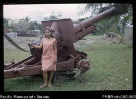 "Lavinia (part-Gilbertese) posing next to Japanese WW2 gun, Guadalcanal Club, Honiara"