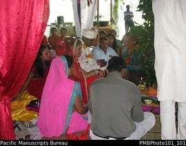 [Suva Wedding  Savita the bride seated beside Mahen the groom and relatives]