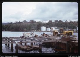 'Partially completed piers of copra wharf, with Shell depot behind, Honiara'
