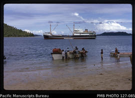 'Workboat discharging cargo onto beach at Lomaloma, Vanua Balavu island, with MV Komaiwai, Fiji'