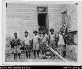 Group of ni-Vanuatu builders outside sawn timber building