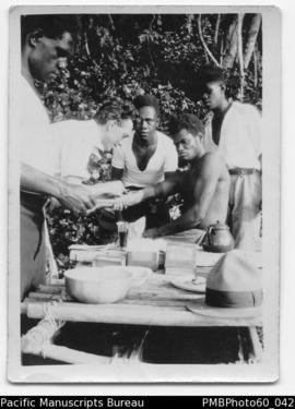 Mr Tulley with three ni-Vanuatu students administering shots/vaccine