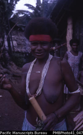 [Woman holding lime stick and bamboo] 'Near Kolovale village, Guadalcanal'