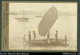 Mounted photograph of five Papua New Guinean men in a canoe with sail.