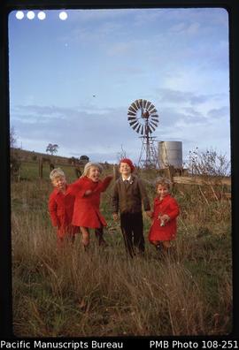 [Group of children in front of windmill]