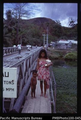 "Young woman from Bellona on Matanikau bridge, Honiara"