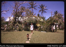 'Front garden, house, Liz Baker and dog Snooky at 30 Beach Road, Suva, Fiji'