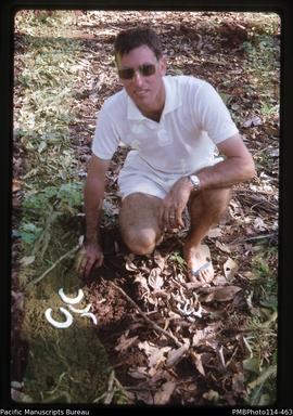 'Ken Cox (Customs Officer) with custom shell money found buried in bush on Gizo Island'
