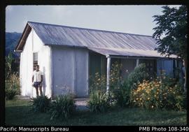 [ni-Vanuatu man standing outside building]