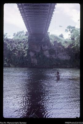 'Under Lunga Bridge, Guadalcanal - Chu Chu from Geology Dept taking river flow readings'
