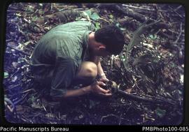 "Ian Geering (VSO) examines skull of Japanese WW2 soldier, new bush gardens inland from Whit...