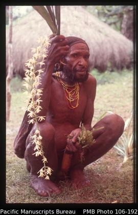[Lani man with orchids]