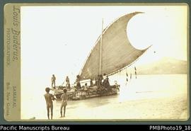 Mounted photograph of people in Papua New Guinean canoe with large sail.