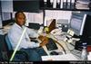 Romias Waki at his desk, AusAID [Port Moresby]