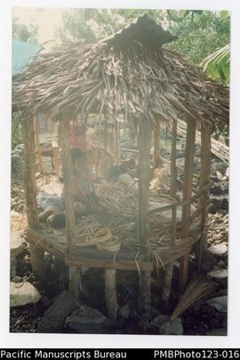 Tatu (Tautino's mother) weaving sleeping mats in the faleoo. Satupaitea, Savaii