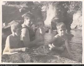 'At the river. October 1940.' Christina, Roger, Donovan and Janet Stallan on a rock, Malekula