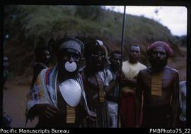 Mt Hagen [group of men some wearing “bilas” - face paint, baler shell, bamboo necklace, Western H...
