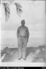 Charles Powell in U.S. navy uniform on the beach at Penrhyn Island