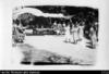 Celebration scene with Cook Islander women in dresses and picnic tables, where Dr Tou & Mr Ho...