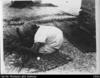 Elderly woman sitting weaving coconut frond mats (Duplicate 0f 29a)