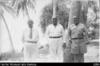 Capt Viggo Rassmussen, Phillip Woonton, and Andy Thomson standing by coconut palms
