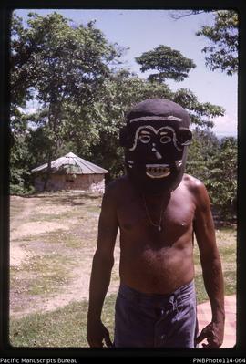 'Tini wearing a devil mask, Geology Dept, Honiara'