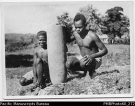 Two ni-Vanuatu males with an earthenware urn
