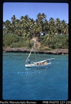 'Closeup view of one of sailing cuttters set against island, Tonga'