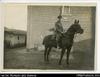 Photograph of a man in military uniform on a horse