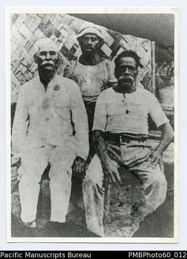 Pastor Juda with two other men. Enoch's father George behind.