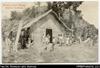 Mission school building with children in front (postcard). Written on front: 'Mission School Hous...