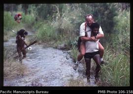 German Tourist carried by Dani man through the river, Bailem Valley