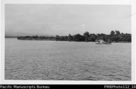 [Untitled] [Madang, Madang District;  small boat and coastline]