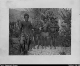 Man with three women and three children standing outside, probably Wintua, South West Bay, Malekula