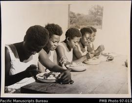 Ebuli hostel girls having their midday meal, Onesua