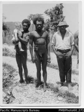 Three ni-Vanuatu men with one holding a European baby (possibly Janet Hallam)