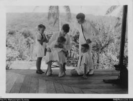 Stallan family on verandah, probably Wintua mission house, South West Bay, Malekula