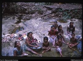 'Woman doing washing in the creek with children, Wagina Island'