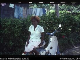 "Maria Tekua of Geological Surveys Department on Honda 50 CC motorcycle, Honiara"