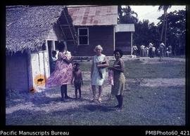 Nancy Smith with two ni-Vanuatu women and children at Tangoa Village Church