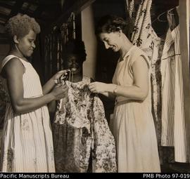 Matron Sister Rhoda Vickers shows Ebuli hostel girls how to hang up new dresses