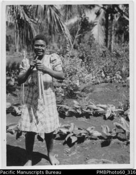 ni-Vanuatu woman holding two bamboo pipes