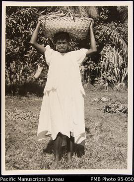 [Woman with basket on head]