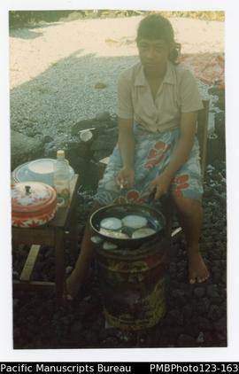 Child of a teacher at Uesiliana College making pancakes. Satupaitea, Savaii