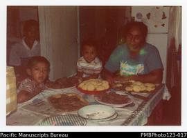 Sivao with her children (Laumua  and Tiuli) with Tautino's brother Ieti, making biscuits for cont...