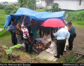 [Suva Wedding  The ceremony outside the bride's family home.  Bridegroom, priest, ?, guests being...