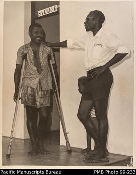 Pasor Silas talks with a patient at the French hospital, Tanna