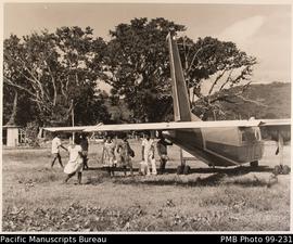 Group of Ni-Vanuatu boarding small plane
