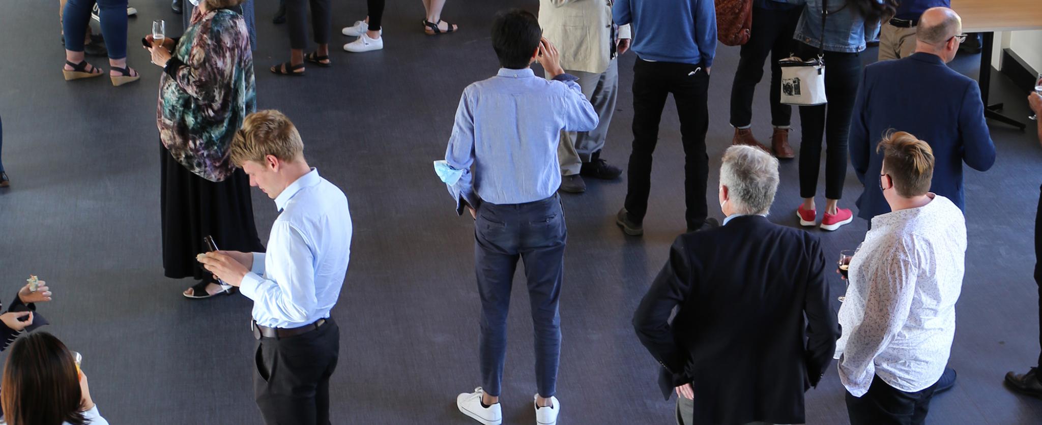 People standing around in the CAP tearoom 