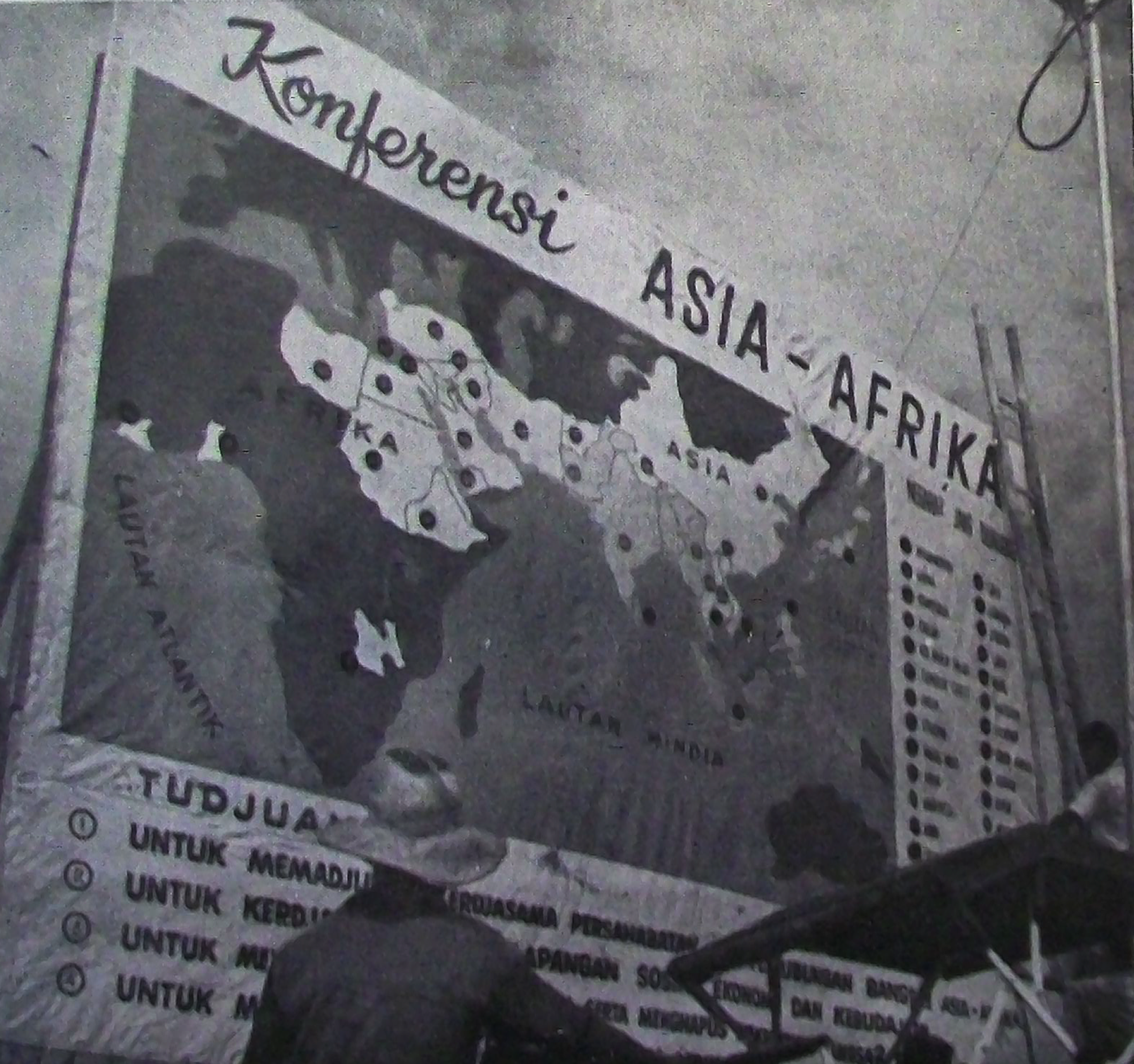 "A 'Betjak' driver reads one of the Conference posters." Page 11 of the Asian-African Conference Bulletin, No. 9. April 25, 1955; published by the Indonesian Ministry of Information. Sourced via Wikipedia Commons.